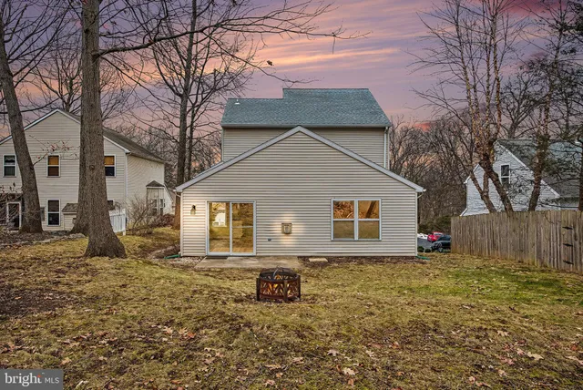 a view of a house with a yard covered in snow