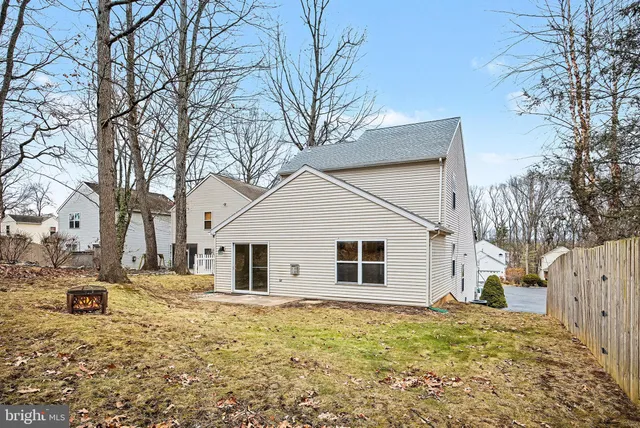 a view of white house with a yard covered with snow