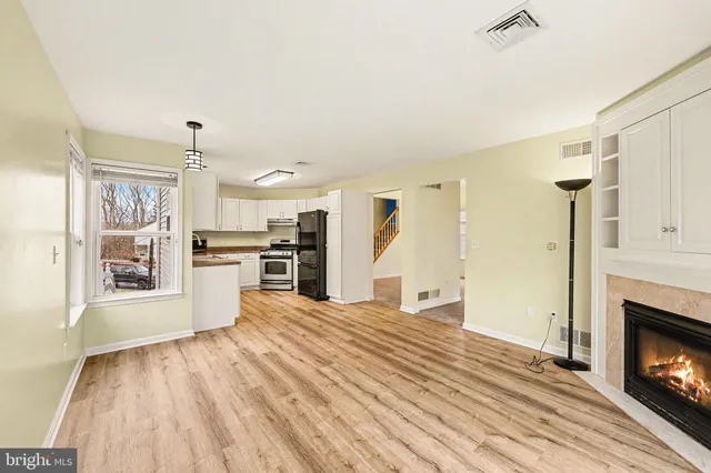 a view of a livingroom with an empty space and a fireplace