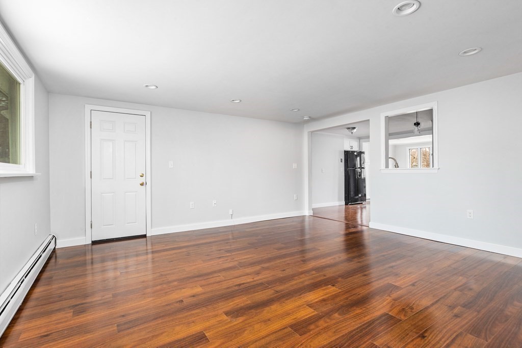 44 Rhodes Circle, Unit 44 Hingham, MA 02043 - Photo 11 of 23 a view of an empty room with wooden floor