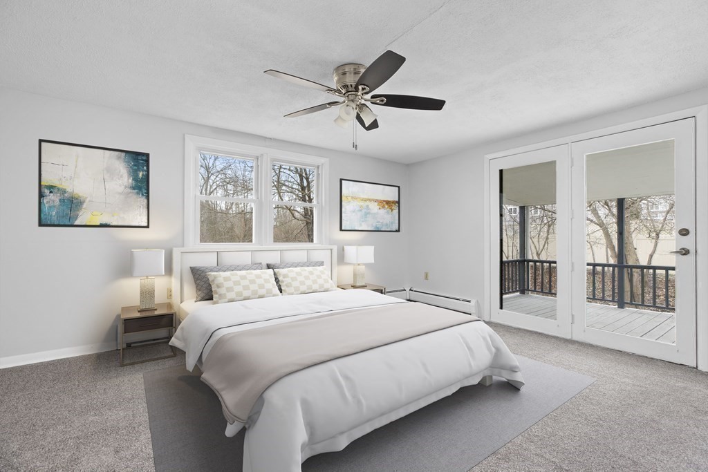 44 Rhodes Circle, Unit 44 Hingham, MA 02043 - Photo 13 of 23 a bedroom with a large bed and a chandelier