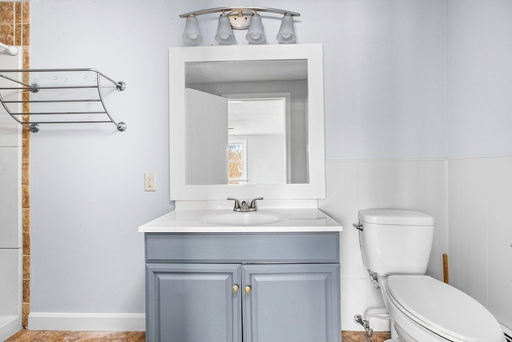 44 Rhodes Circle, Unit 44 Hingham, MA 02043 - Photo 15 of 23 a bathroom with a toilet sink vanity and mirror