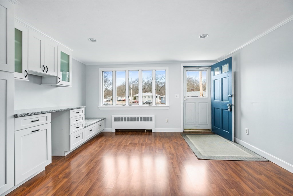 44 Rhodes Circle, Unit 44 Hingham, MA 02043 - Photo 6 of 23 an empty room with windows and wooden floor