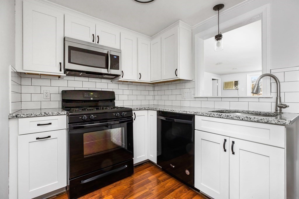 44 Rhodes Circle, Unit 44 Hingham, MA 02043 - Photo 7 of 23 a kitchen with white cabinets and appliances