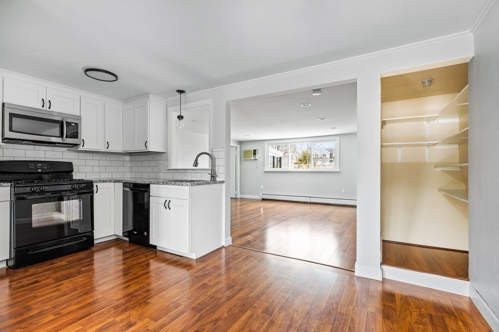 44 Rhodes Circle, Unit 44 Hingham, MA 02043 - Photo 8 of 23 a kitchen with granite countertop a refrigerator and a stove top oven