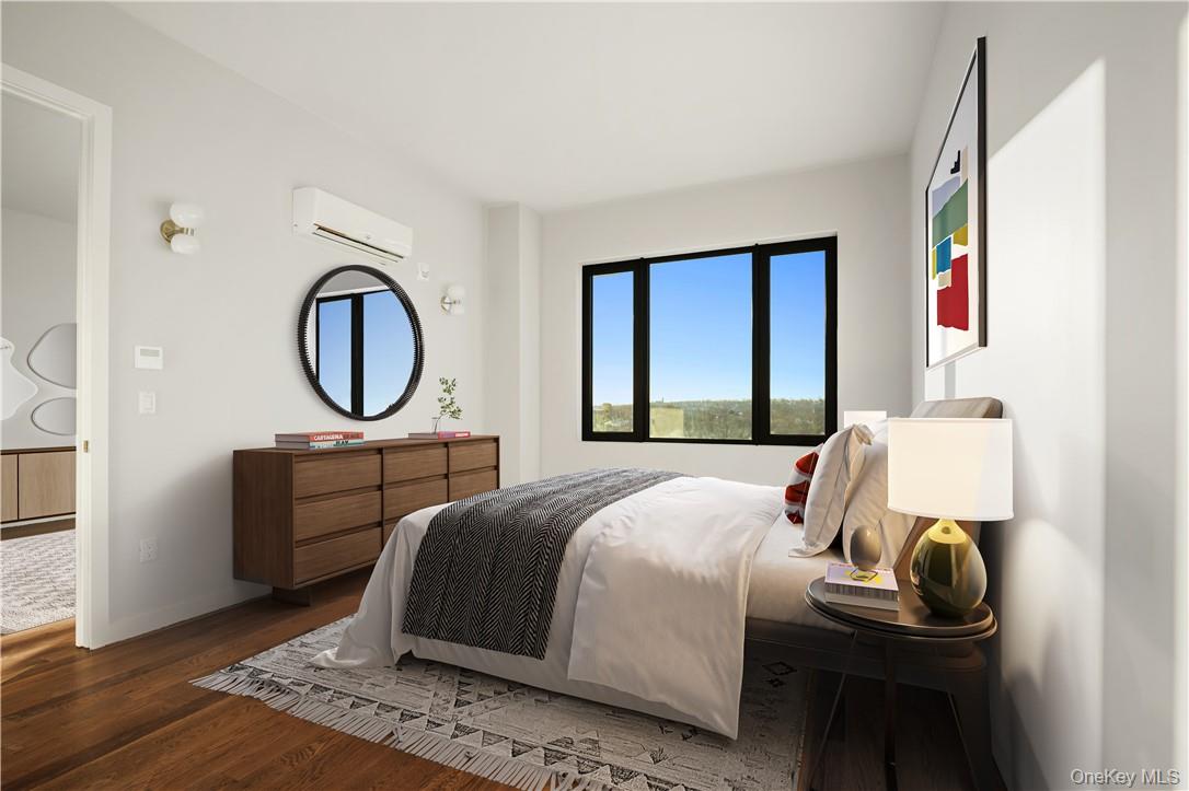 601 Ridge Hill Boulevard, Unit 704 Yonkers, NY 10710 - Photo 4 of 8 a bedroom with a bed a mirror and a window