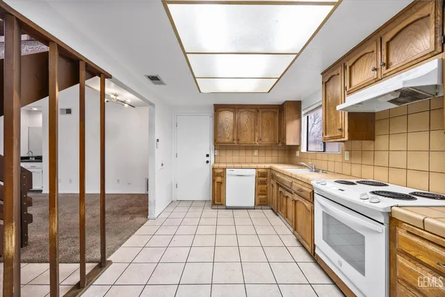 a kitchen with a stove a sink and a refrigerator