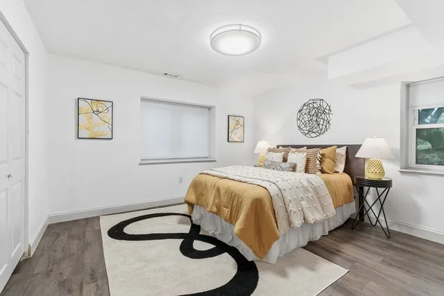 a bedroom with a bed and painting on the wall