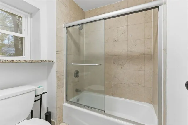 a bathroom with a shower and a toilet
