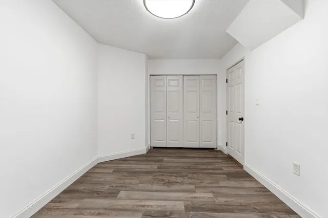 a view of a room with wooden floor