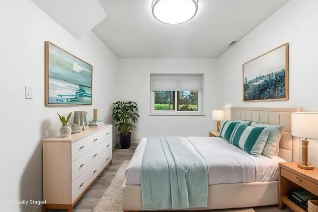 a bedroom with a large bed and a chandelier