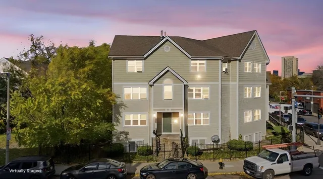 a front view of a residential apartment building with a yard