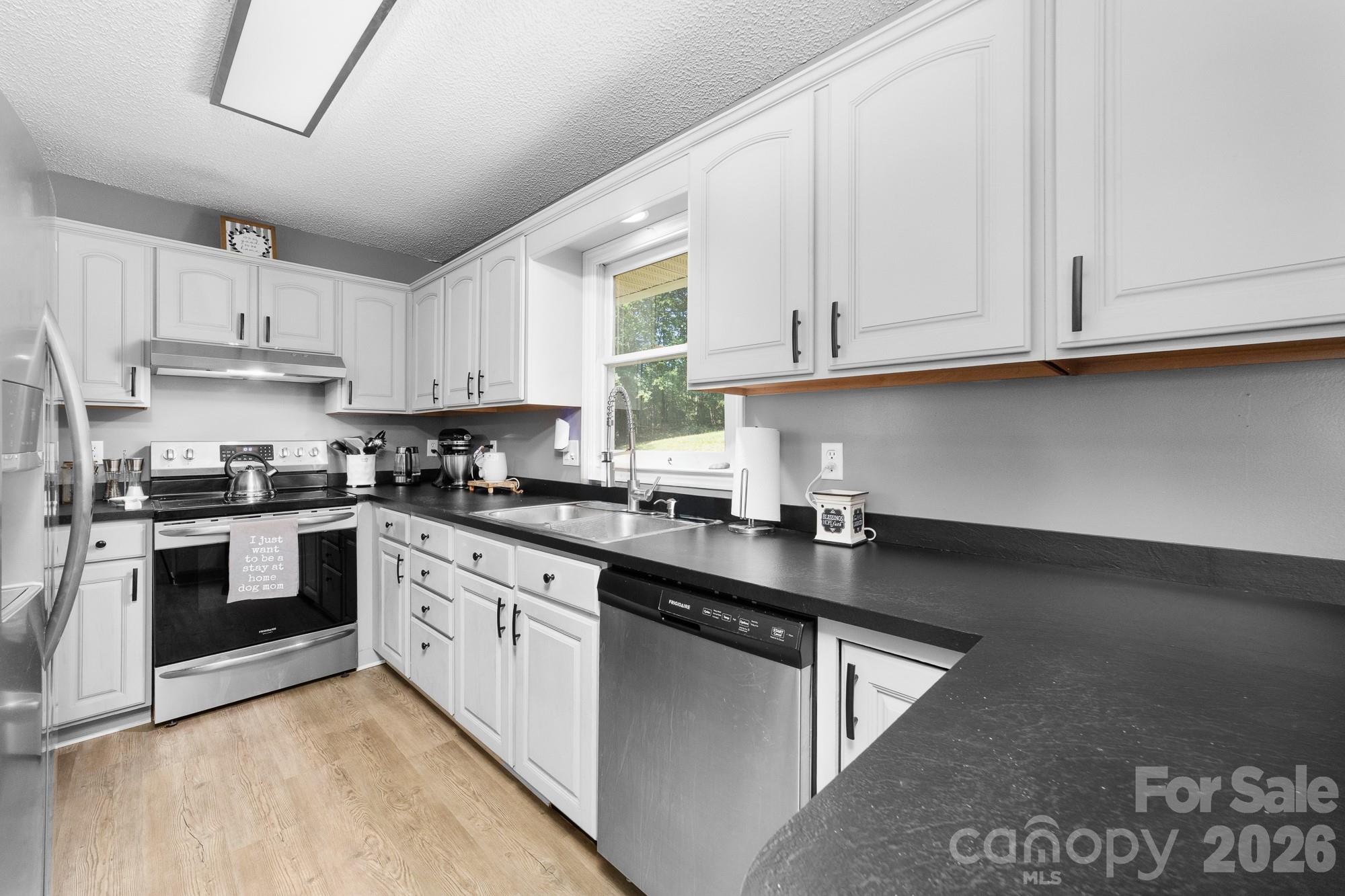 248 Jack McKinney Road Forest City, NC 28043 - Photo 23 of 29 a kitchen with granite countertop white cabinets and a sink