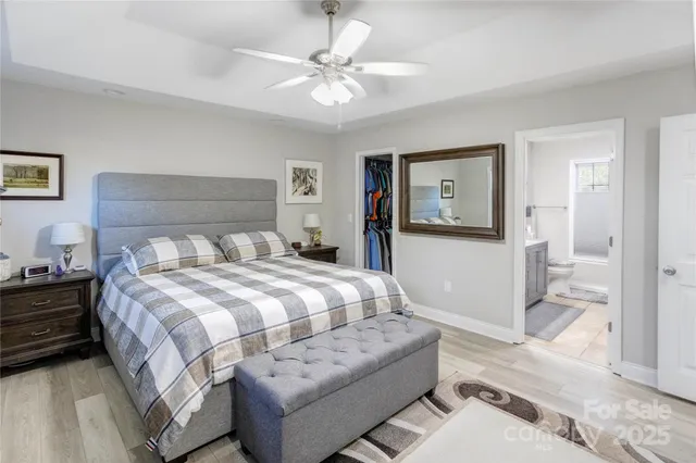 a bedroom with a large bed and a chandelier