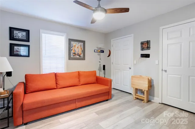 a blue couch sitting in a living room next to a lamp