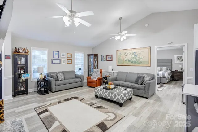 a living room with furniture ceiling fan and a rug