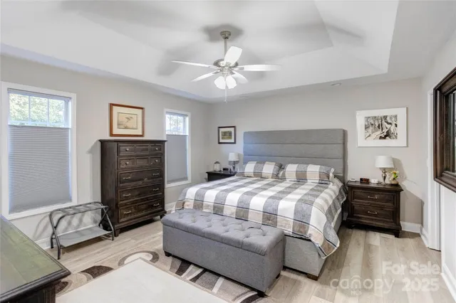 a bedroom with a bed and ceiling fan