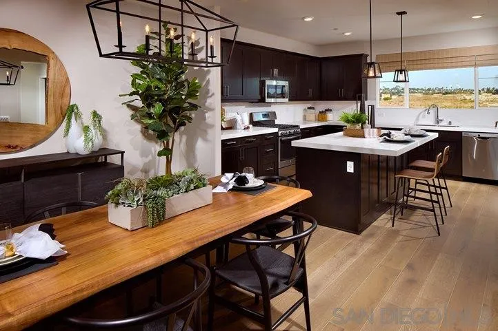 3543 Conner Way Oceanside, CA 92056 - Photo 1 of 17 a kitchen with a table chair and white cabinets