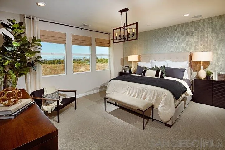 3543 Conner Way Oceanside, CA 92056 - Photo 8 of 17 a spacious bedroom with a bed a couch and a window