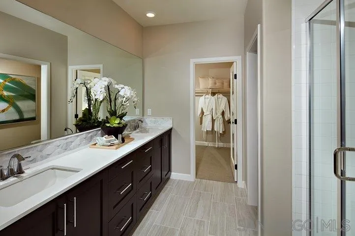 3543 Conner Way Oceanside, CA 92056 - Photo 9 of 17 a bathroom with a double vanity sink and a mirror