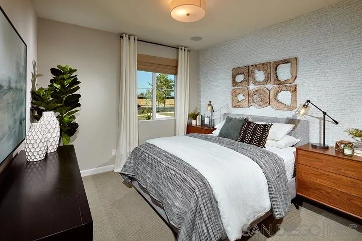 3543 Conner Way Oceanside, CA 92056 - Photo 10 of 17 a bedroom with a bed and a potted plant