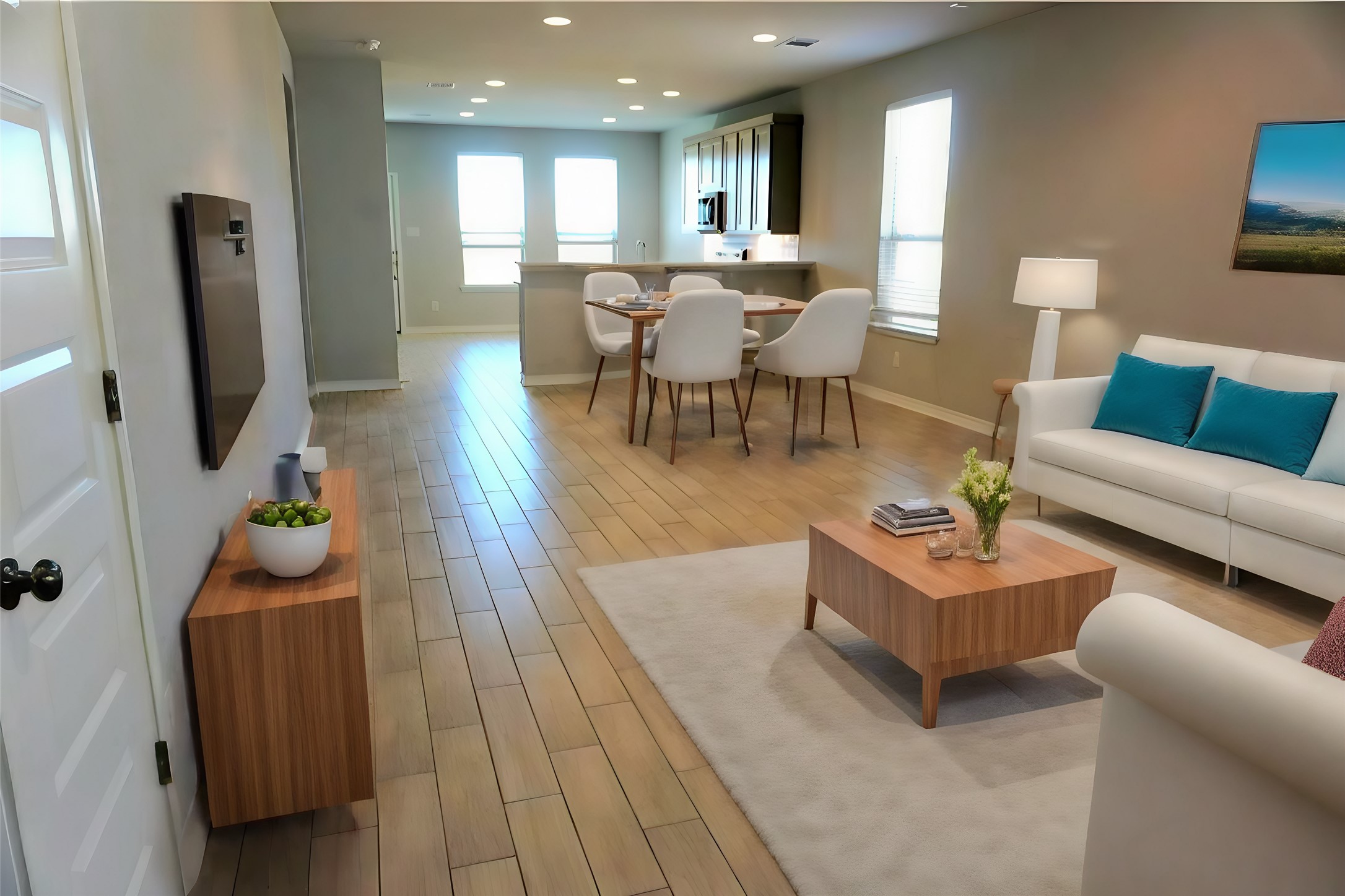 104 Batjac Alley Jarrell, TX 76537 - Photo 3 of 11 Open-concept living space featuring wood-finish flooring, recessed lighting, and multiple windows