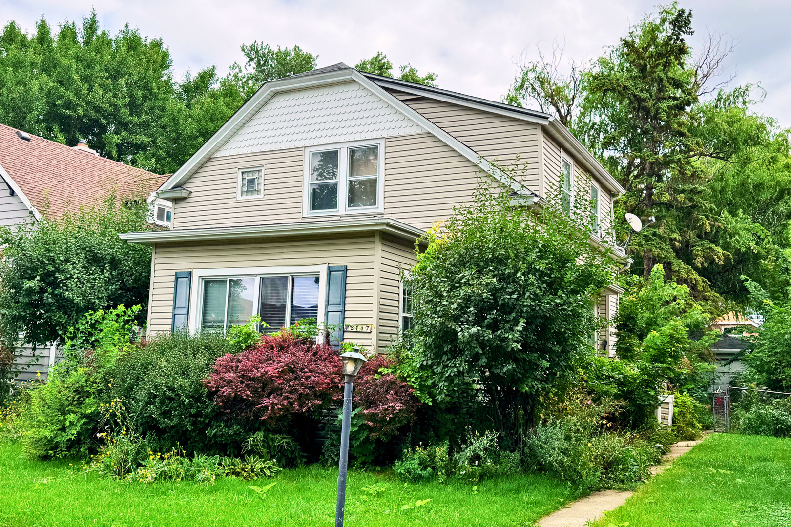 a view of a house with potted and flower plants