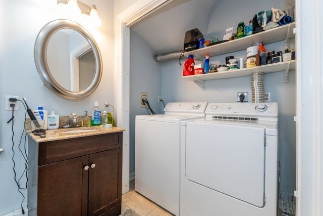 a utility room with sink dryer and washer