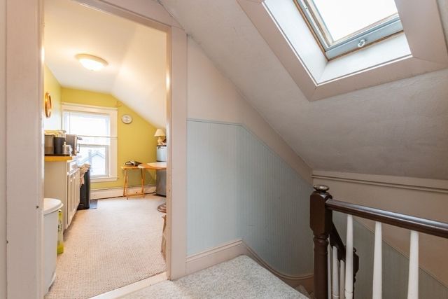 a view of a hallway with a livingroom and a bathroom