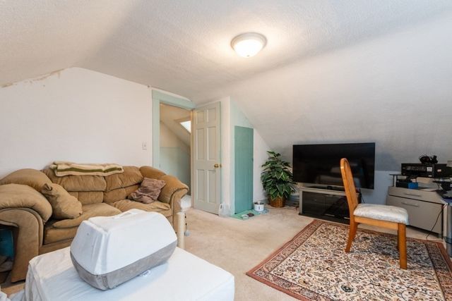 a living room with furniture rug and wooden floor