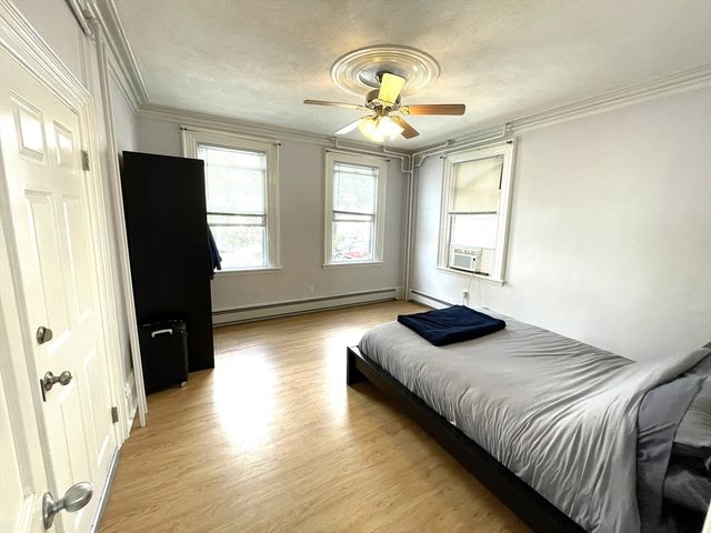 a bedroom with a bed and wooden floor