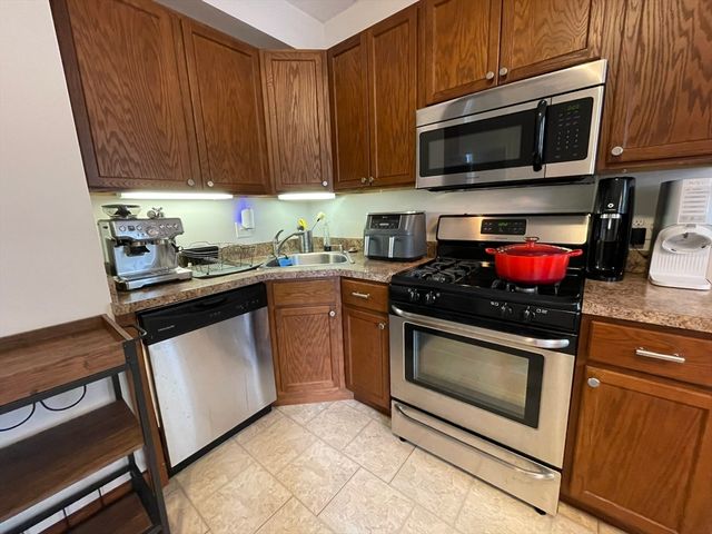 a kitchen with a stove microwave and sink