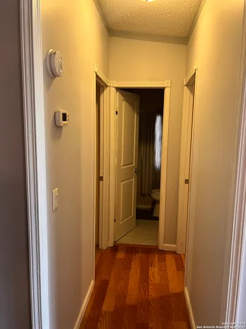 a white toilet sitting next to a white cabinet