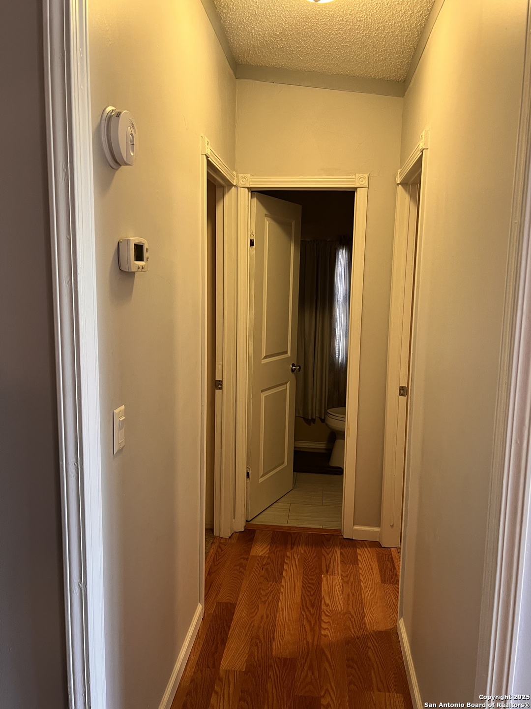 7614 Von Ormy Road Von Ormy, TX 78073 - Photo 17 of 27 a view of a bathroom with a glass door and a wooden door