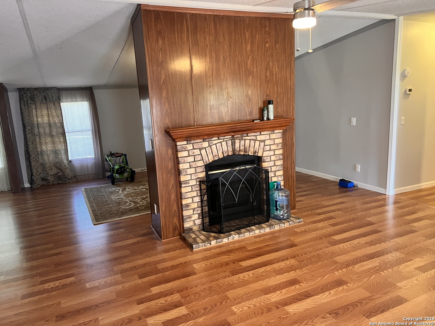 7614 Von Ormy Road Von Ormy, TX 78073 - Photo 20 of 27 a view of fireplace and wooden floor