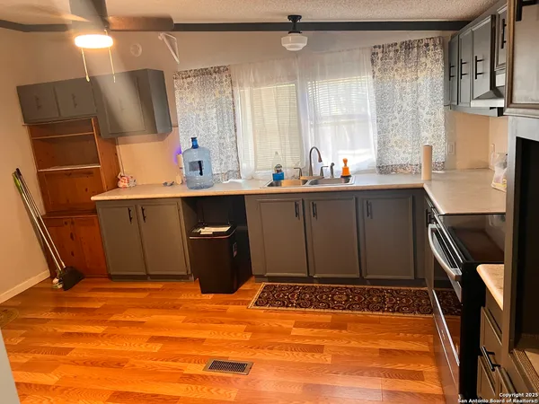 wooden floor in a hall with an entryway and a window