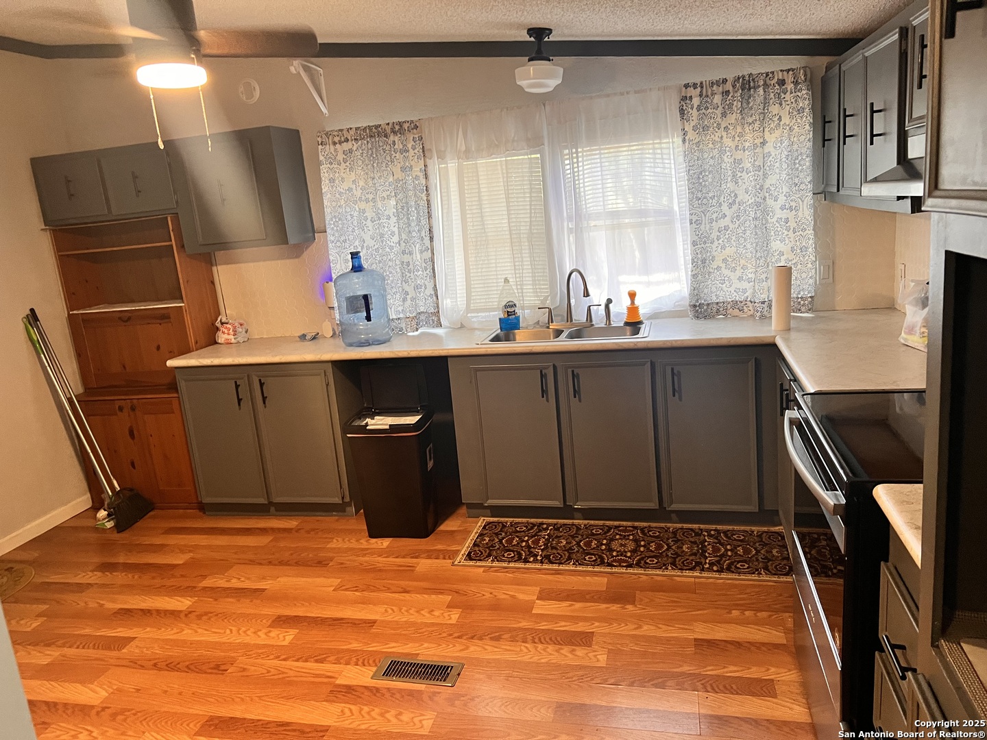 7614 Von Ormy Road Von Ormy, TX 78073 - Photo 22 of 27 a bathroom with a sink a mirror and a bathtub