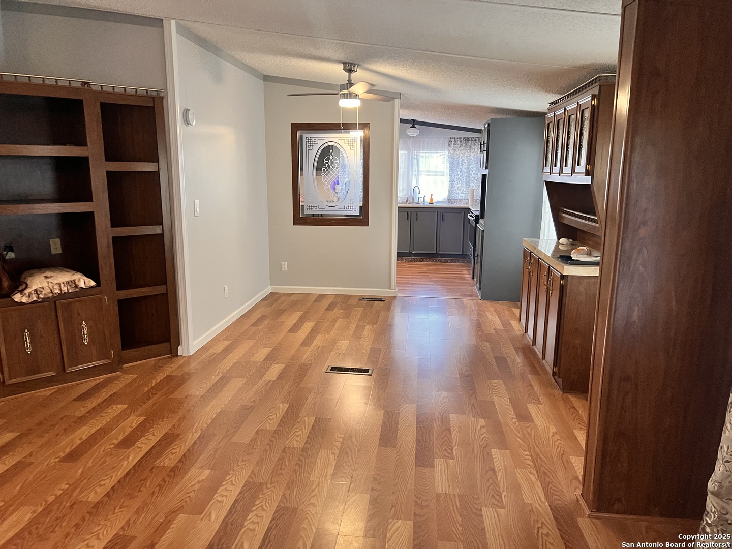 7614 Von Ormy Road Von Ormy, TX 78073 - Photo 23 of 27 wooden floor in a hall with an entryway and a window