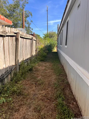 a view of a pathway of a house with a small yard