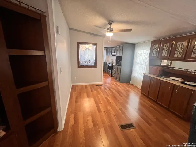 an empty room with wooden floor and closet