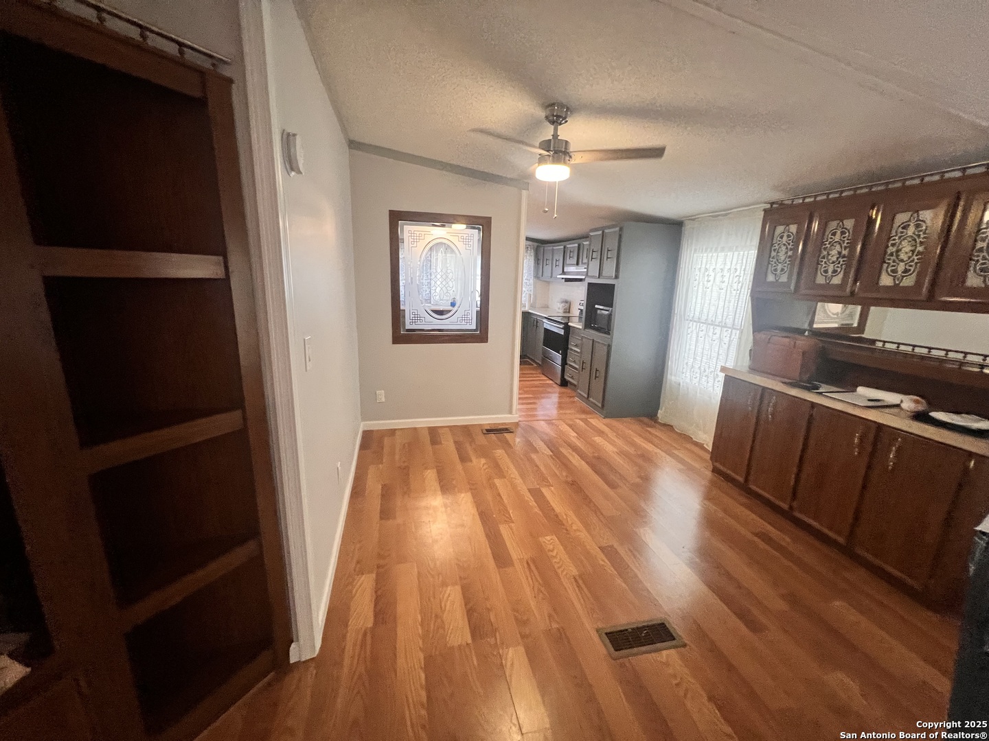 7614 Von Ormy Road Von Ormy, TX 78073 - Photo 8 of 27 a view of a living room with wooden floor