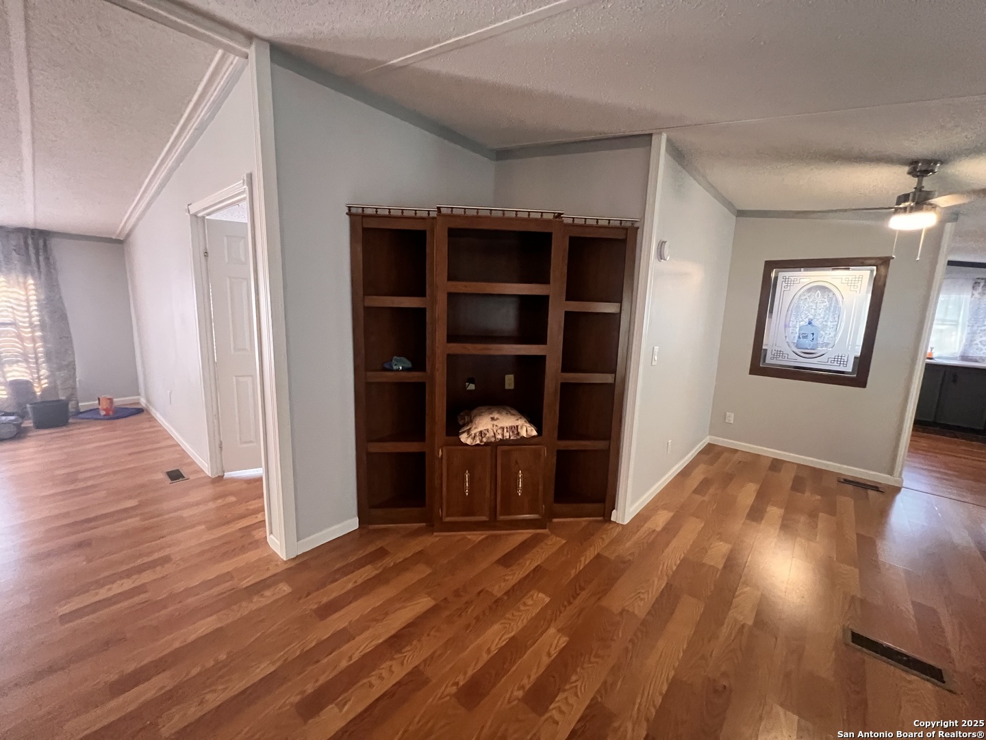 7614 Von Ormy Road Von Ormy, TX 78073 - Photo 9 of 27 an empty room with wooden floor and closet