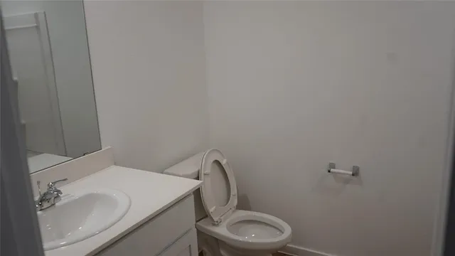 a white toilet sitting next to a white sink