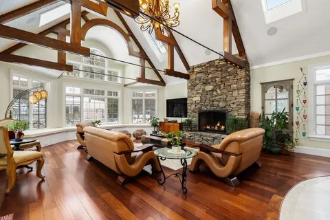 a living room with furniture a fireplace and wooden floor