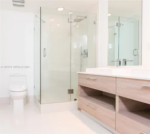 a bathroom with a sink a toilet and a shower