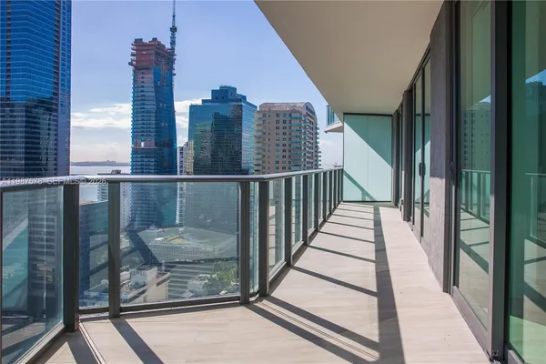 a view of balcony with wooden floor and fence