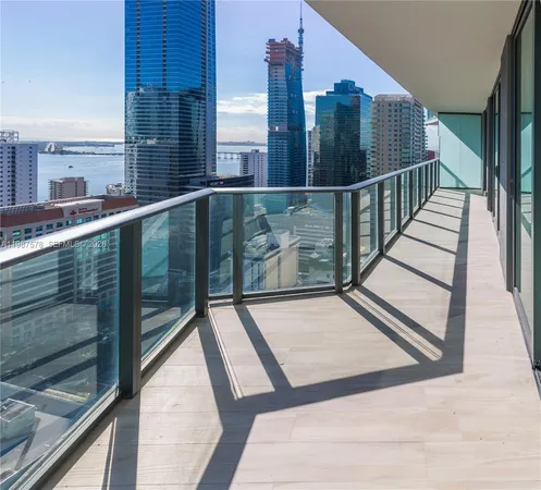 a view of balcony with wooden floor and fence and city view