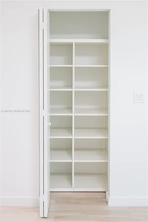a view of a walk in closet with empty racks