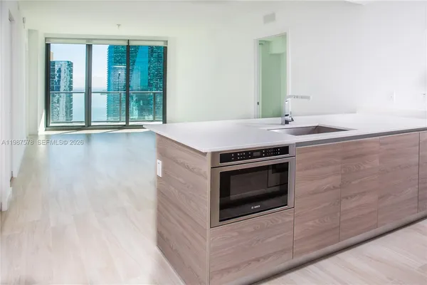 a kitchen with granite countertop a stove and a sink