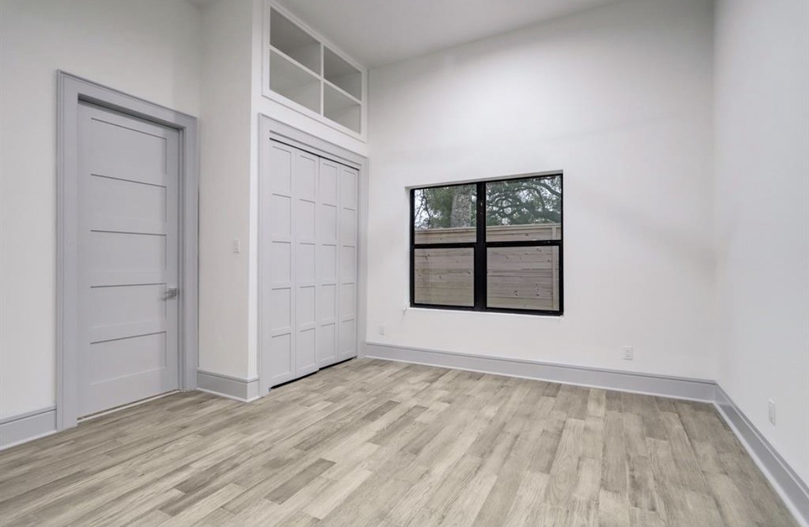 1709 Reverse Street Houston, TX 77055 - Photo 17 of 29 an empty room with wooden floor and windows